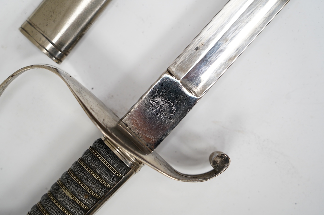 An 1861 Austrian sabre with intaglio initialled hilt and Solingen blade, in its steel scabbard, plated overall, blade 76cm. Condition - good